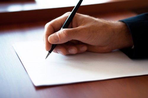 Man writing on the paper in the office