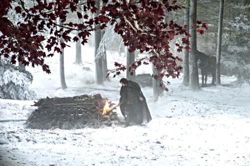 Service for one: With tears in his eyes, a dutiful and beleaguered Jon Snow lights his lover Ygritte's pyre.